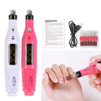 Nail drill machine with accessories on a white background