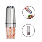 Electric pepper grinder seasoning food during home cooking
