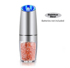 Stainless steel salt grinder with pink Himalayan salt on a white background